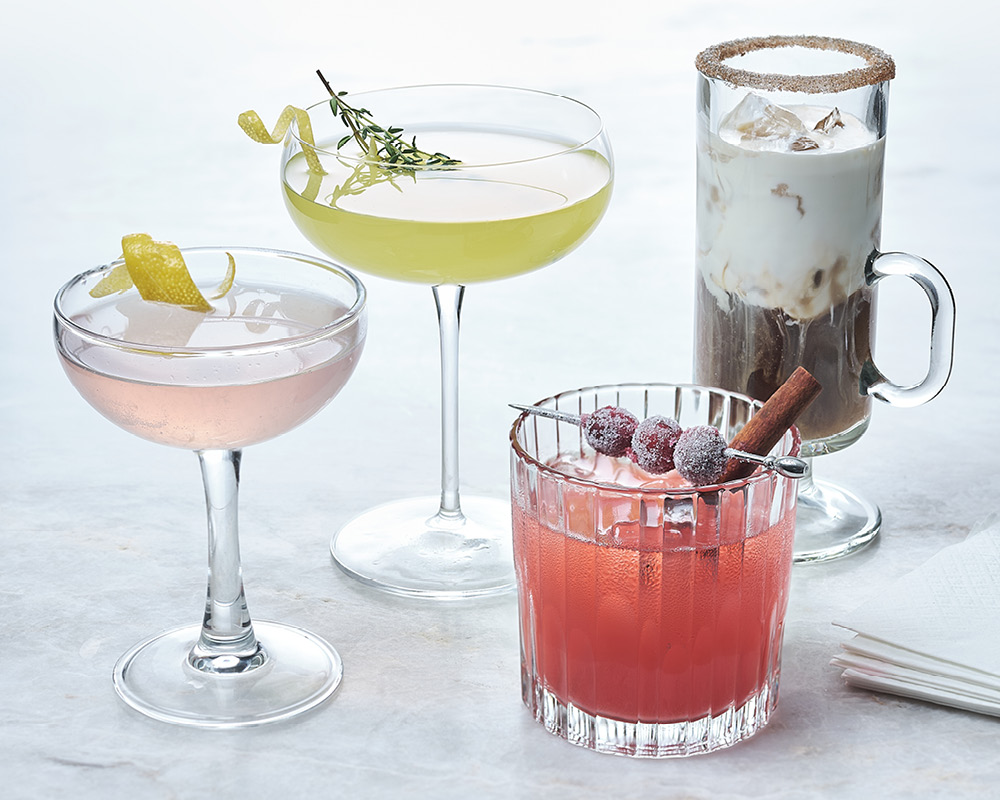 Four cocktails on a white and gray background