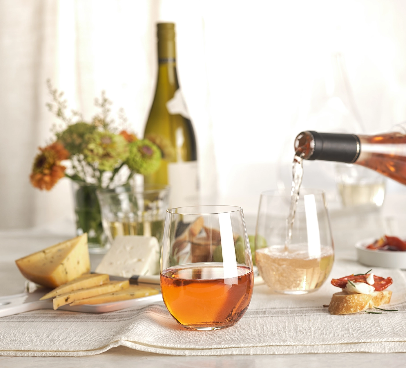 A glass of rose and a glass of sparkling wine.