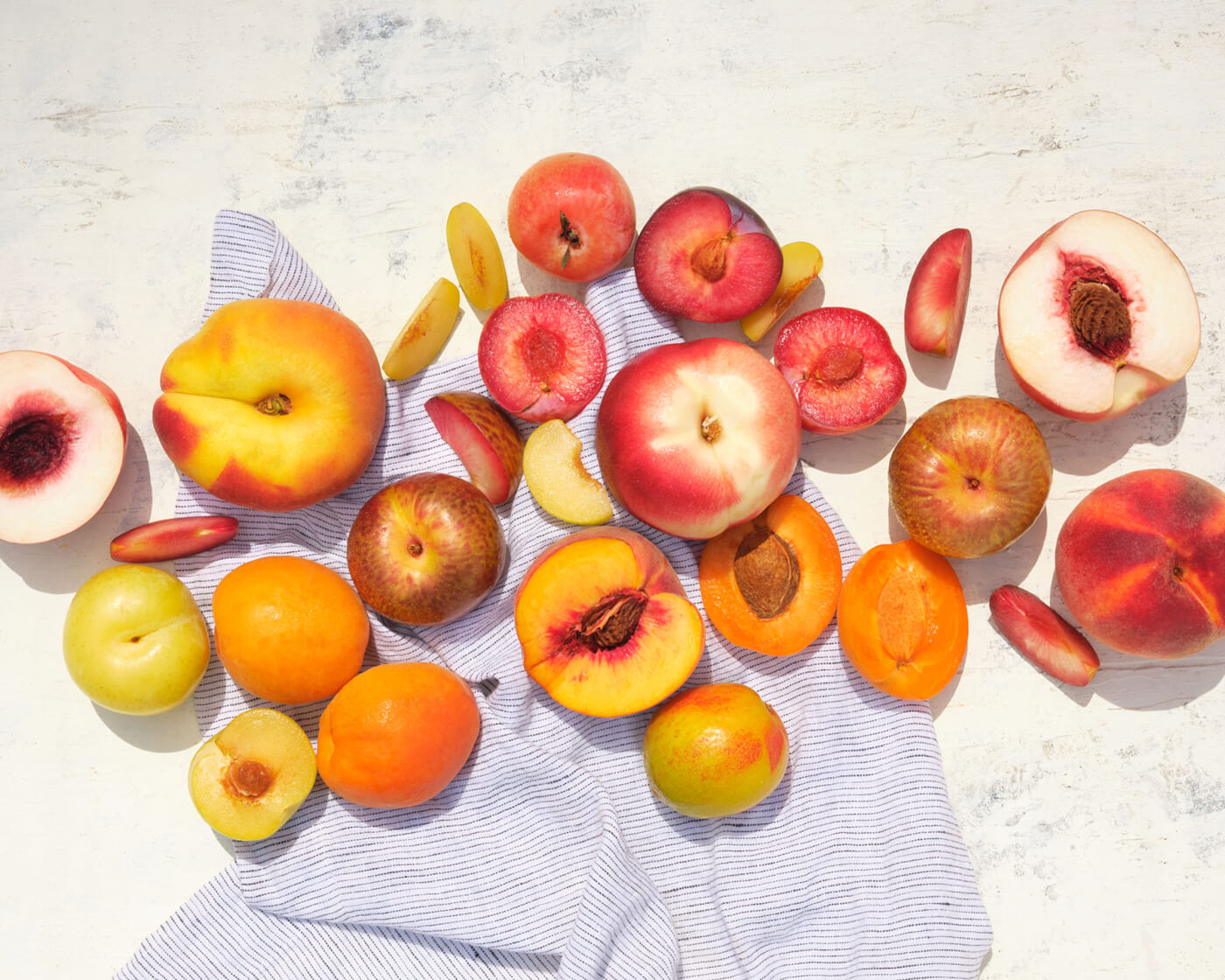 assorted stone fruit with a napkin