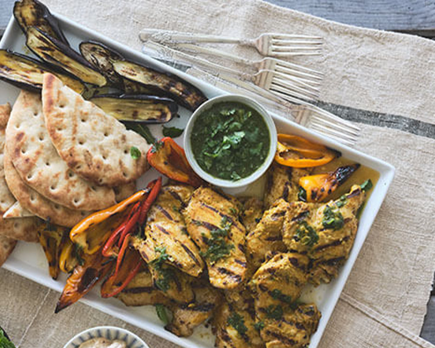 grilled chicken and vegetables and pita and green sauce