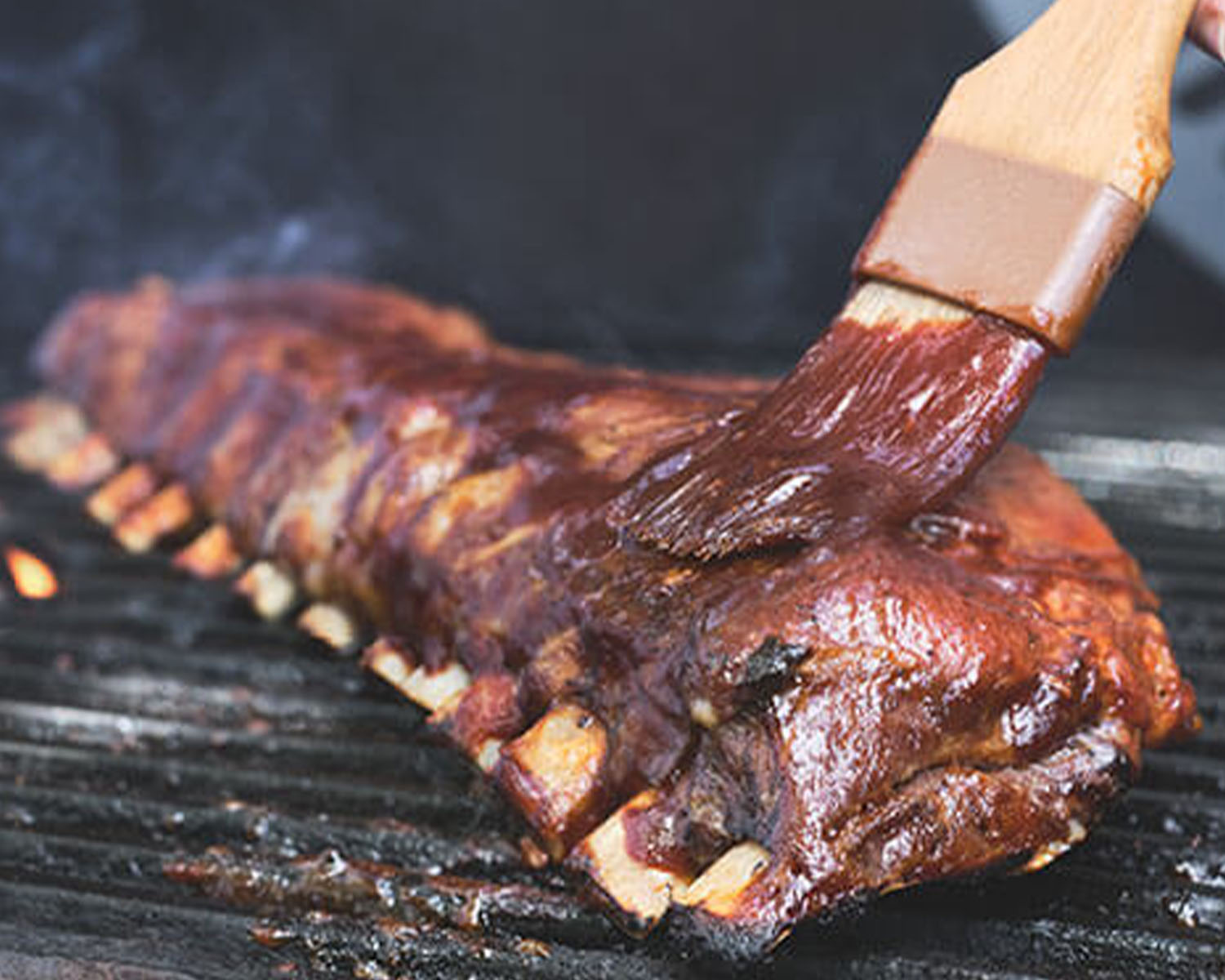 bbq ribs on the grill with sauce