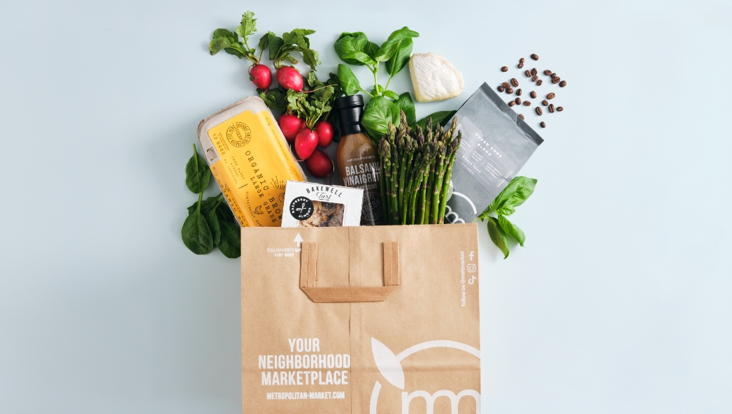 Grocery Bag with spring items coming out the top