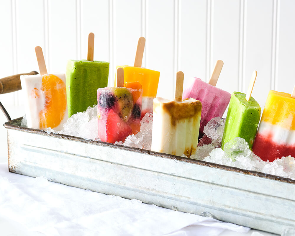 Popsicles placed upside down in a bucket of ice