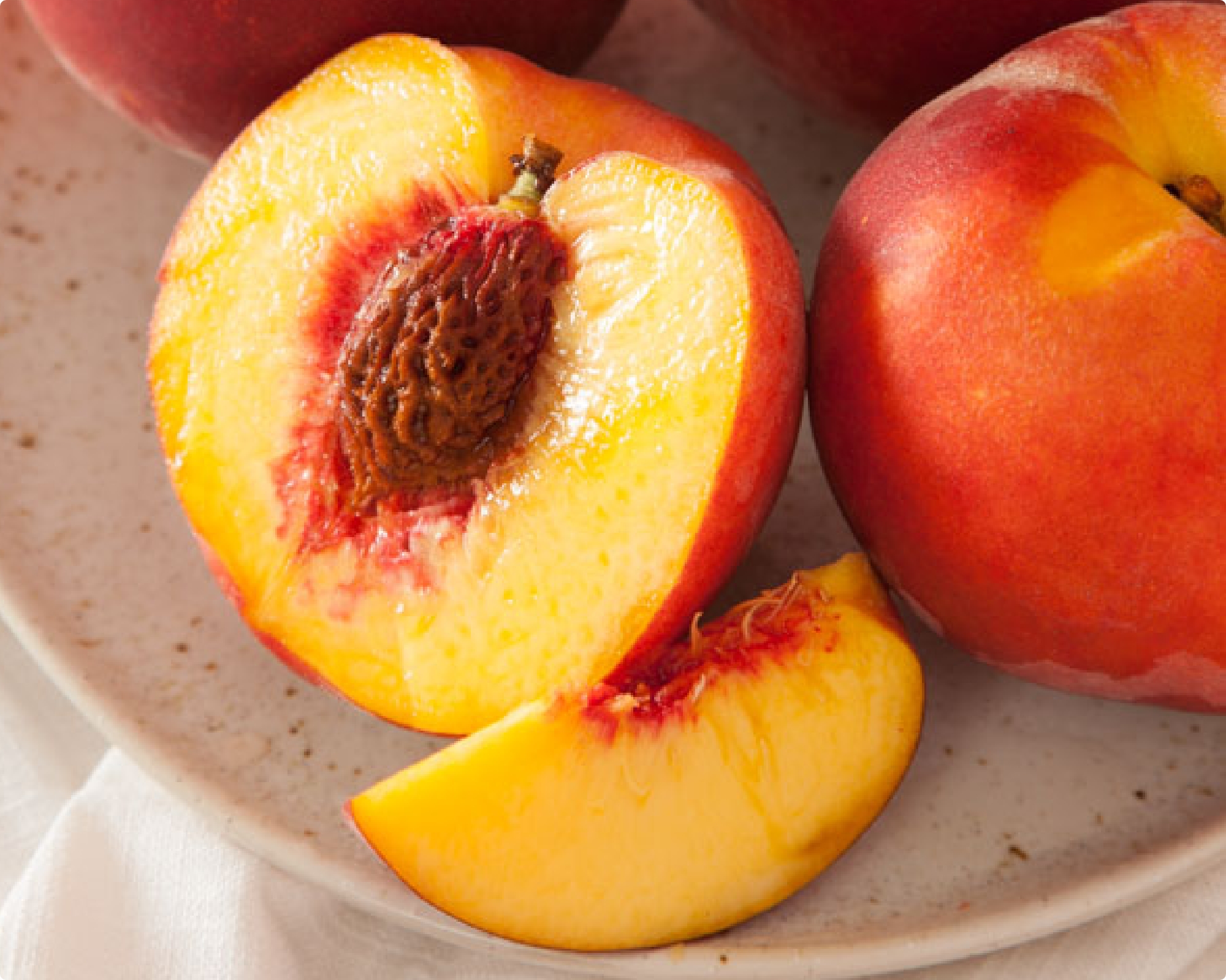 Halved peach with wedge