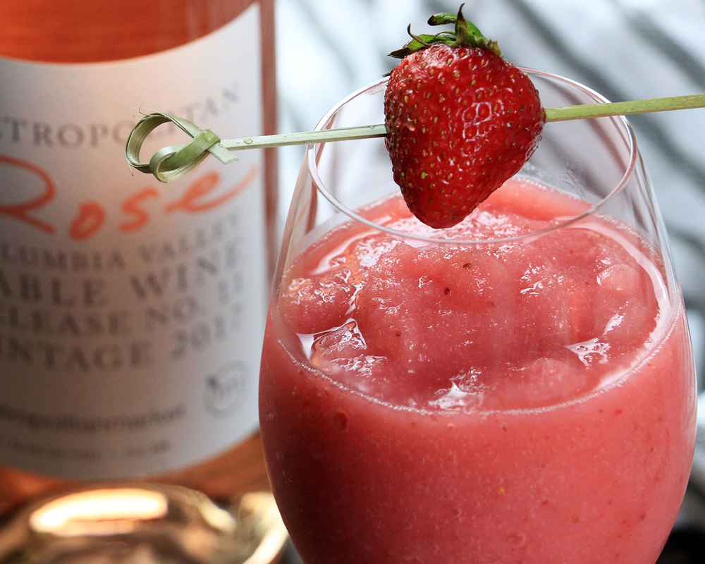Strawberry frose in a glass with a strawberry skewer garnish
